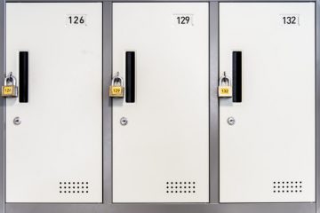 Locked white lockers with padlocks